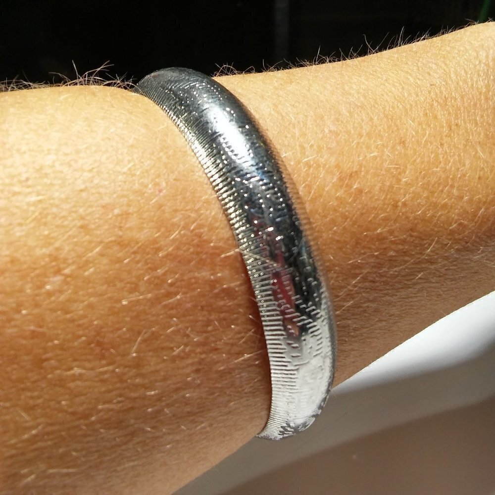 Women`s silver tone etched bangle bracelet. 2 3/4